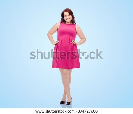female, gender, portrait and people concept - smiling happy young plus size woman posing in pink dress over blue background