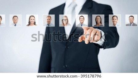 human resources, career management, recruitment and success concept - man in suit pointing to of many business people portraits