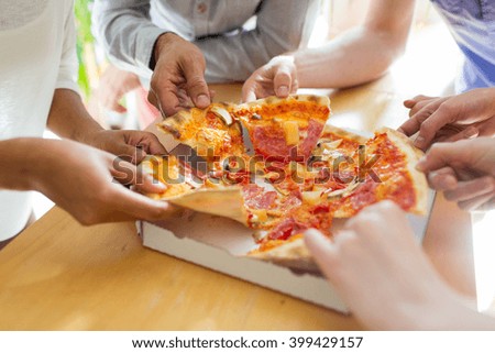 food, lunch and people concept - close up of friends or people eating pizza