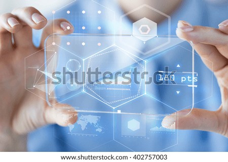 business, technology, analytics, science and people concept - close up of woman hand holding and showing transparent smartphone with virtual chart hologram on screen at office