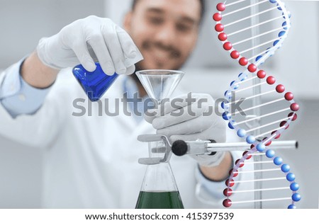 science, chemistry, biology, medicine and people concept - close up of scientist filling test tubes with funnel and making research in clinical laboratory