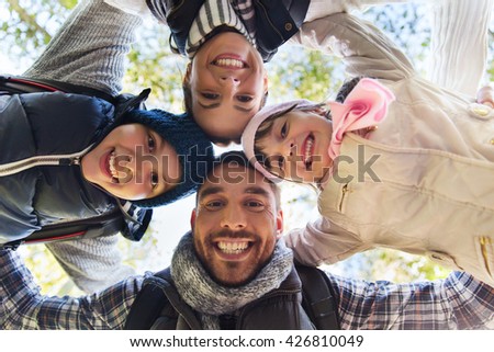 camping, travel, tourism, hike and people concept - happy family faces outdoors at camp in woods