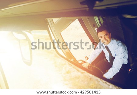 transport, transportation, tourism, road trip and people concept - close up of smiling driver reflection in passenger bus mirror