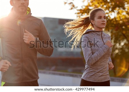 fitness, sport, people and lifestyle concept - couple running outdoors