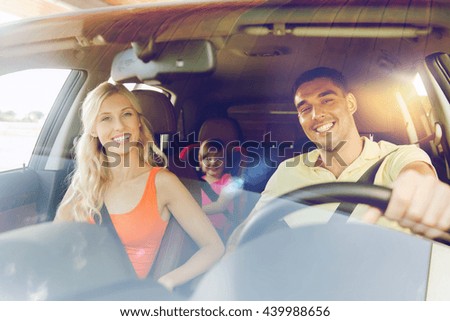 family, transport, safety, road trip and people concept - happy man and woman with little child driving in car