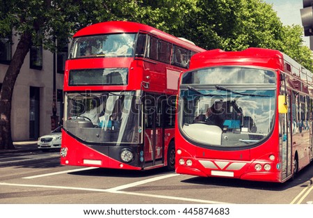 city life and public transport concept - city street with red double decker buses in london
