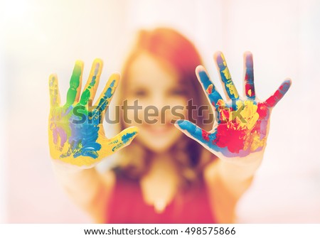 education, art, people, childhood and drawing concept - little happy student girl showing painted hands