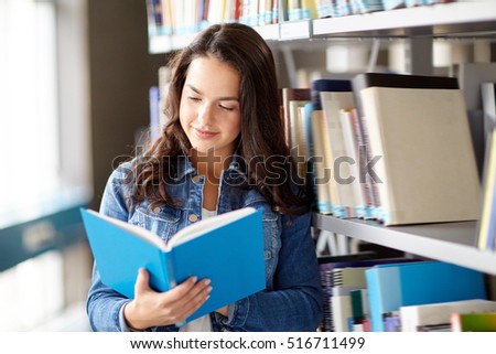 education, high school, university, learning and people concept - smiling student girl reading book at library