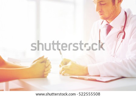 close up of patient and doctor taking notes