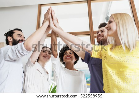 business, startup, gesture, people and teamwork concept - happy creative team making high five in office
