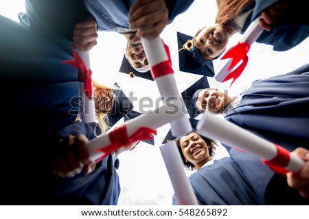 education, graduation and people concept - group of happy international students in mortar boards and bachelor gowns standing in circle with diplomas