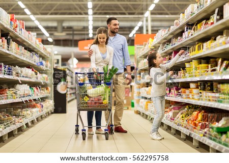 sale, consumerism and people concept - happy family with child and shopping cart buying food at grocery store or supermarket
