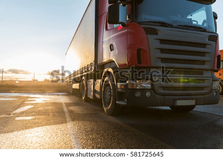 transportation, freight transport and vehicle concept - close up of truck on parking