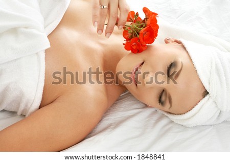 beautiful lady with red flower in spa salon