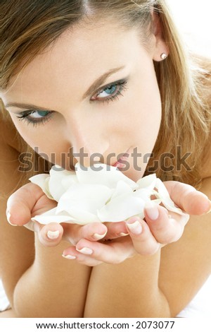 lovely woman in spa smelling white rose petals lovely woman in spa smelling white rose petals