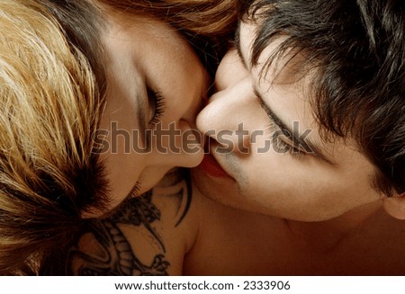 stock photo picture of sweet couple kissing in bed