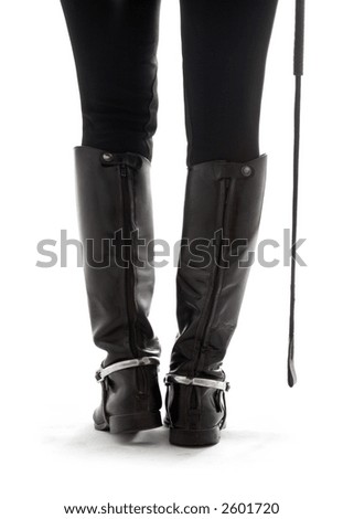 beautiful legs in black leather horseman boots with riding-crop over white - stock photo