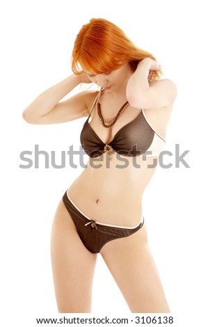 stock photo picture of fit redhead in black and white lingerie