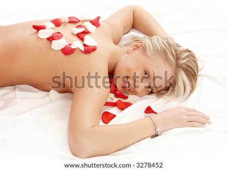 lovely girl with heart-shaped petals in massage salon