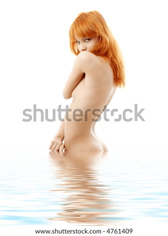 stock photo picture of naked redhead standing in water