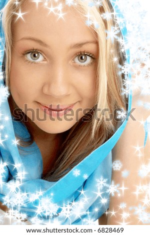 portrait of smiling blond in blue scarf with snowflakes