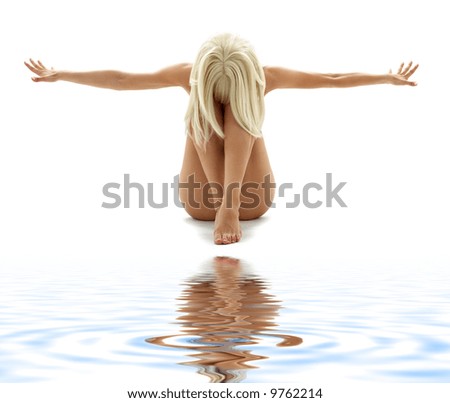 stock photo artistic nudity style picture of woman on white sand
