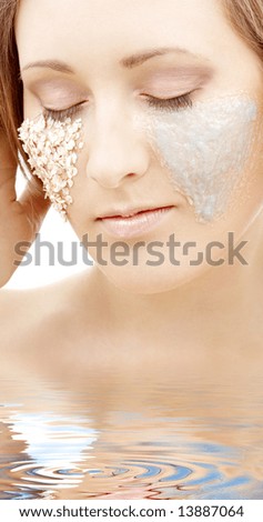 beautiful woman with gel and scrub on face in water