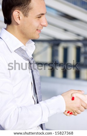 picture of handsome businessman shaking hands with female colleague