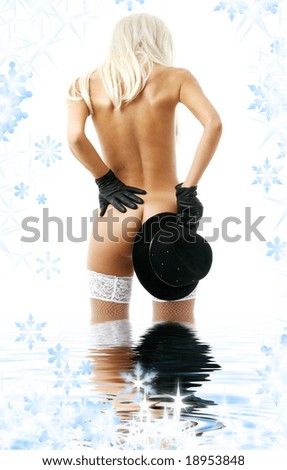 blonde girl with black hat standing in water