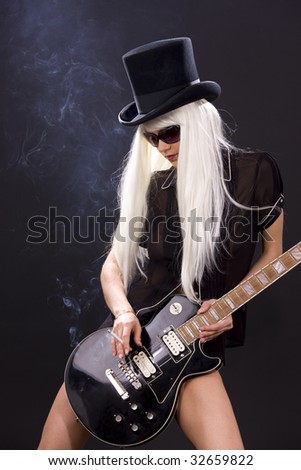 stock photo woman in top hat with black electric guitar and cigarette