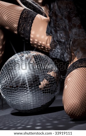 party dancer girl in fishnet stockings with disco ball