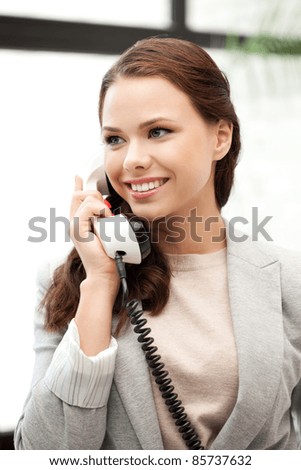 bright picture of happy businesswoman with phone