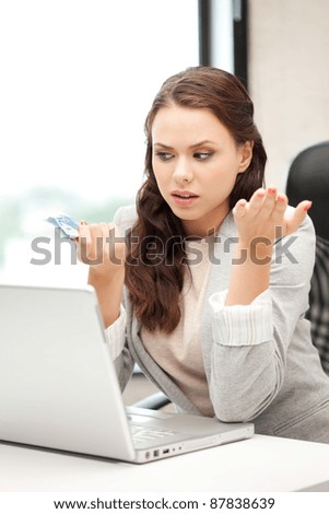 picture of unhappy woman with laptop computer and euro cash money