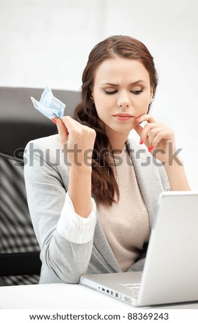 picture of pensive woman with laptop computer and euro cash money