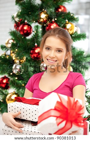 bright picture of happy woman with gift box and christmas tree