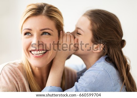 people, trust and family concept - happy daughter whispering secret to her mother