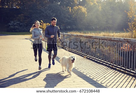 fitness, sport, people and jogging concept - happy couple with dog running outdoors