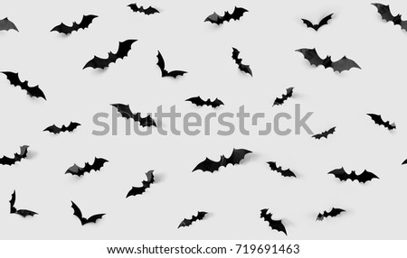 halloween decorations concept - seamless pattern with black paper bats on grey background