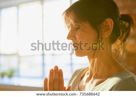 religion, faith, harmony and people concept - close up of yogi woman meditating at yoga studio