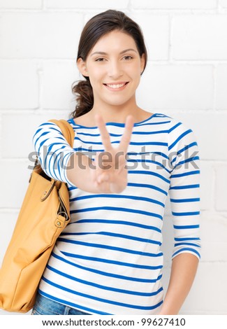 picture of lovely teenage girl showing victory or peace sign