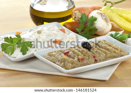 eggplant salad and mayonnaise russian salad decorated with olive oil and vegetables