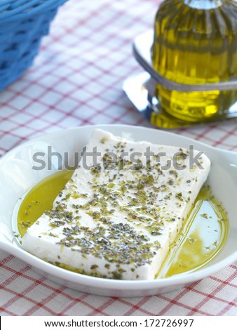 a slice of feta cheese(traditional Greek goat cheese) with virgin olive oil and oregano