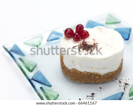 cheese cake shaped as a flower ,decorated with cranberries,syrup and chocolate flakes