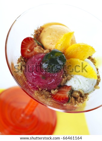 three different flavor fruit ice cream with slices of peach,strawberry and fig.