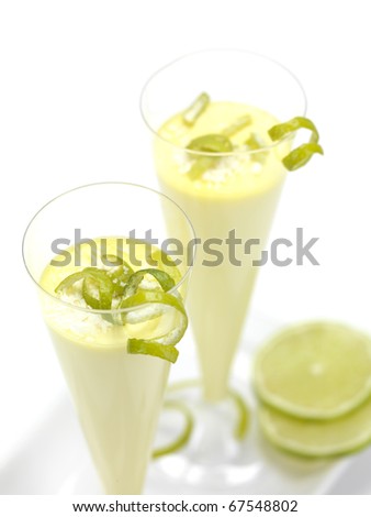 a lemon flavored mousse in a flute glass with lemon serpentines