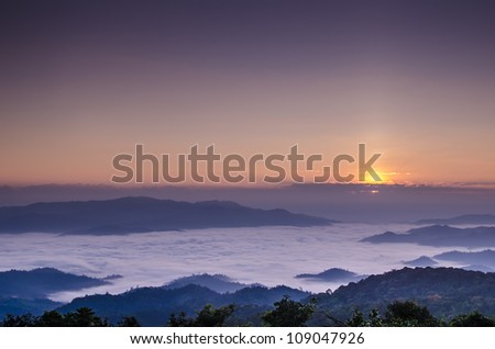 sun rise over a fog and mountain