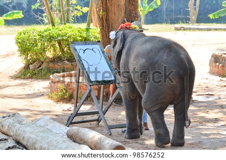 LAMPANG, THAILAND - NOV. 30: The mahout train elephant to draw picture.They have show twice in day. In The Thai Elephant Conservation Center (TECC) at Lampang. November 30, 2011 in Lampang, Thailand.
