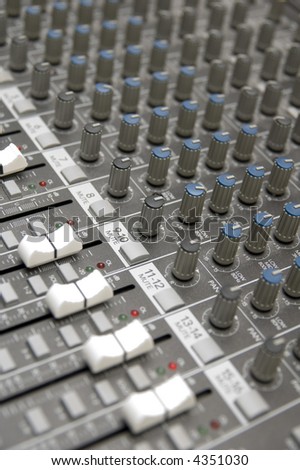 closeup view of a DJ\'s mixing desk with shallow depth of field