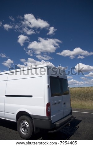 White transit van against a blue sky background