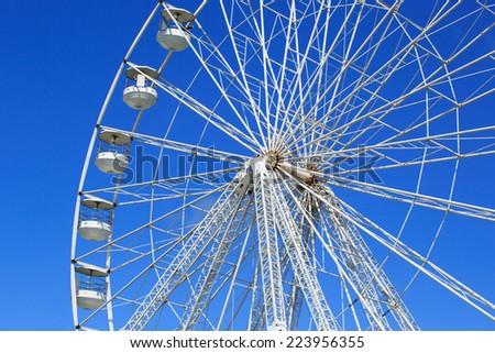 Ferris wheel at a fun fair isolated against blue